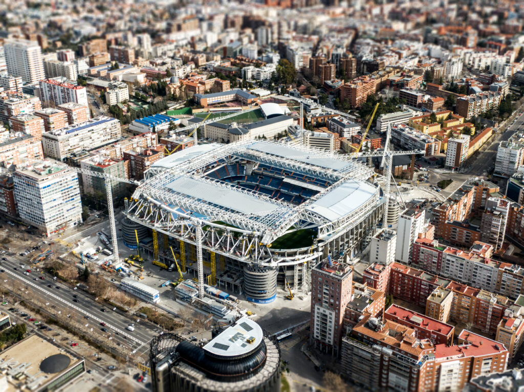 Madrid,  Spain  -  February  05,  2022:  Santiago  Bernabeu  stadium  during  renovation.  Aerial  view xkwx santiago,  bernabeu,  stadium,  renovation,  madrid,  reconstruction,  real,  aerial,  soccer,  view,  city,  football,  royal,  spanish,  spain,  tourism,  drone,  above,  world,  work,  industrial,  real  madrid,  santiago  bernabeu,  high,  progress,  sport,  steel,  travel,  destination,  sky,  structure,  building,  material,  famous,  construction,  crane,  arena,  project,  architecture,  landmark,  uefa