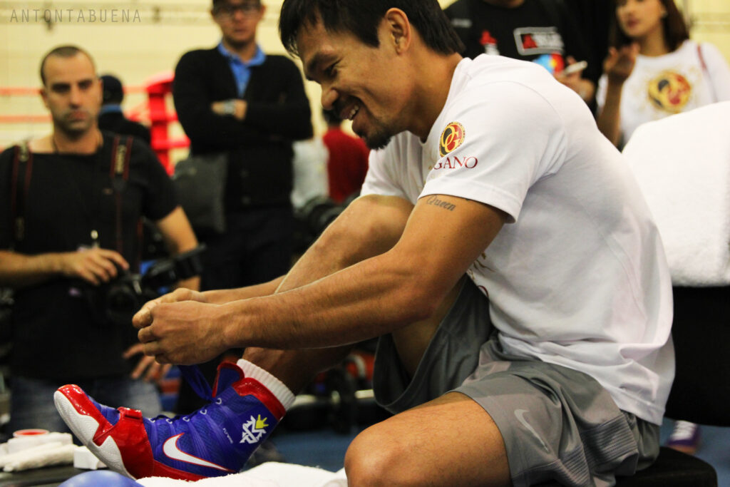 Manny Pacquiao lacing up his boots during training.