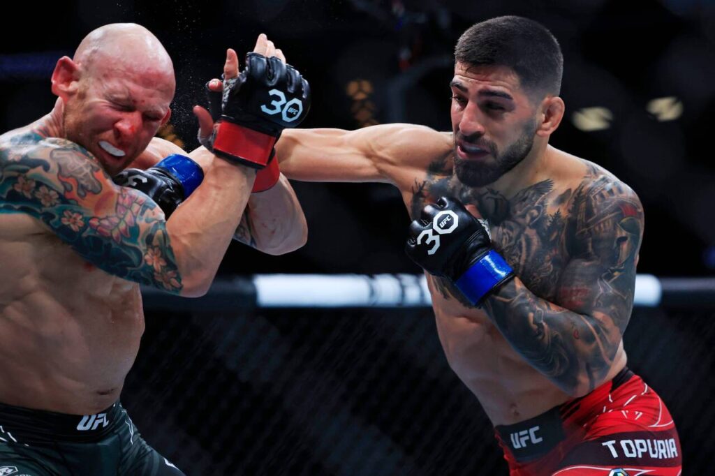 Ilia Topuria lands a punch on Josh Emmett in a featherweight bout during the UFC Fight Night event Saturday, June 24, 2023 at VyStar Veterans Memorial Arena in Jacksonville, Fla. 