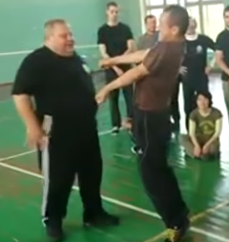 Portly Systema instructor smiles as training partner seizes up.