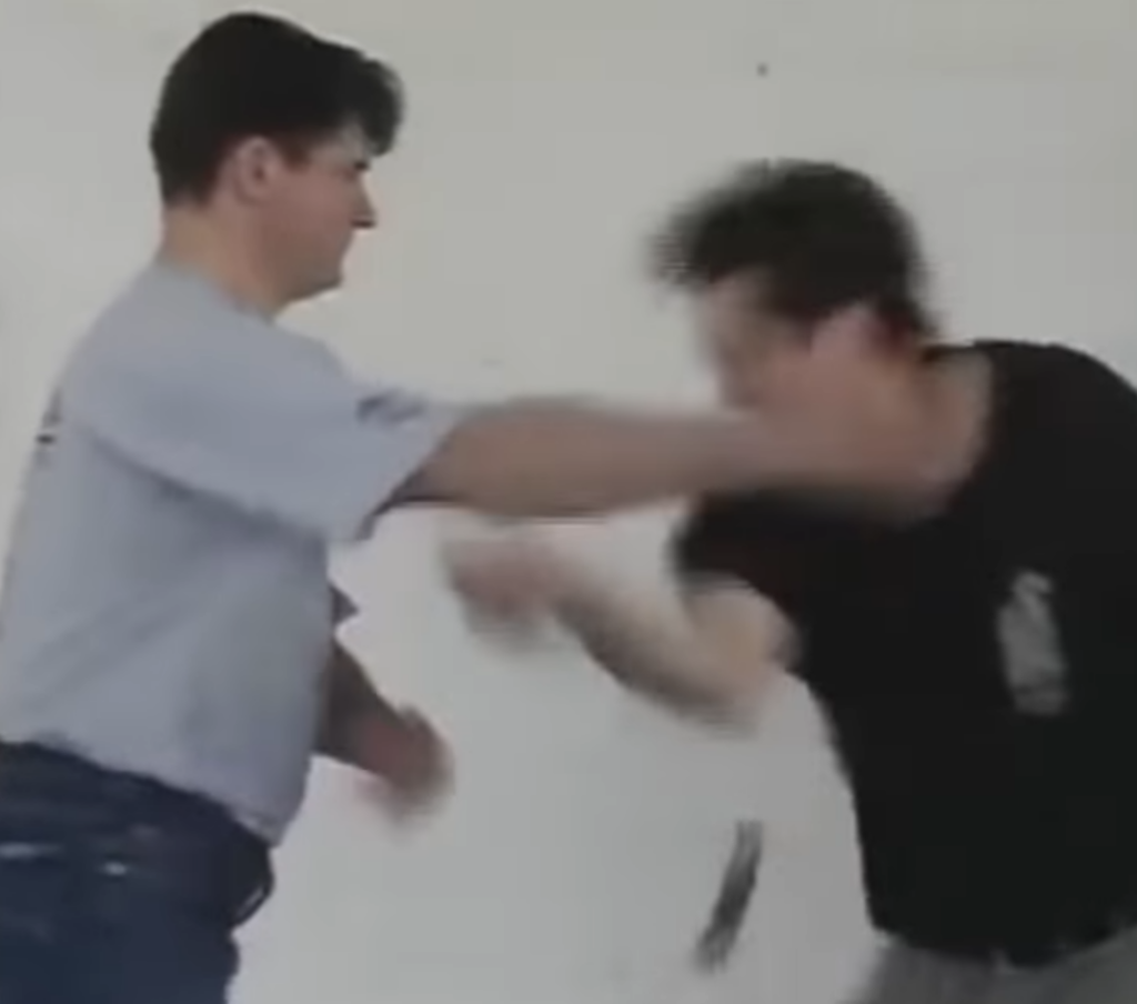 Systema instructor follows up by smacking and cradling head of opponent.