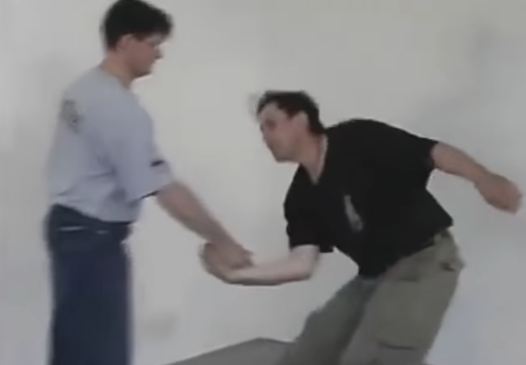 Systema instructor controls the wrist of the now disarmed knife attacker