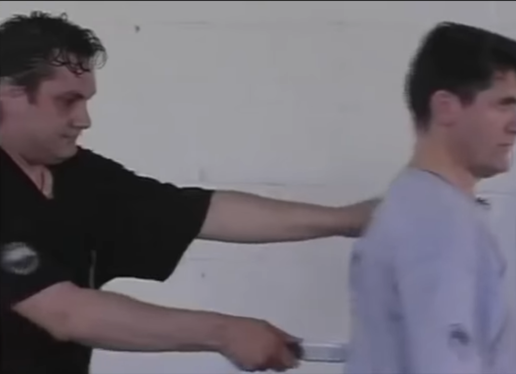 Systema instructor has training partner place a knife to his back